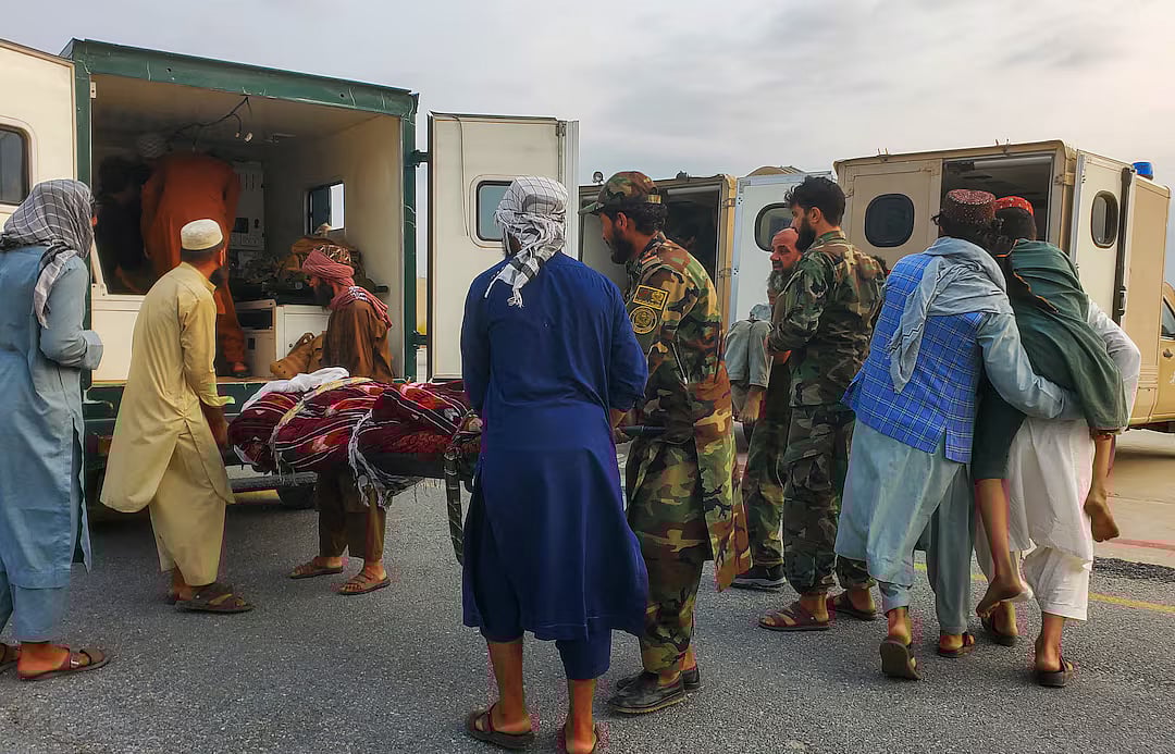 Taliban soldiers and civilians carry earthquake victims to an ambulance at an airport in Jalalabad, Afghanistan, 1 September, 2025.