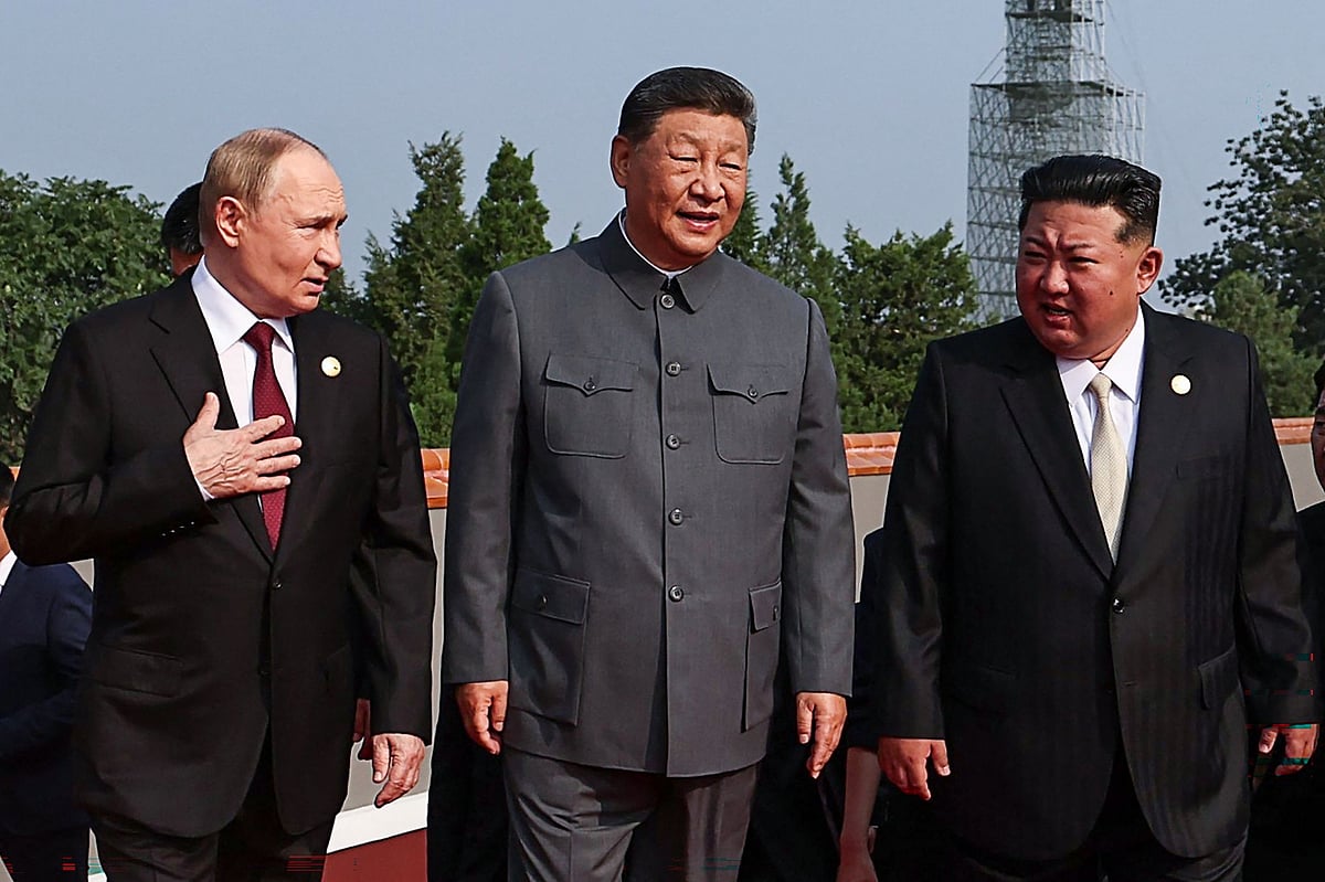 In this pool photograph distributed by the Russian state agency Sputnik, (L-R) Russia’s President Vladimir Putin walks with China’s President Xi Jinping and North Korea’s leader Kim Jong Un before a military parade marking the 80th anniversary of victory over Japan and the end of World War II, in Beijing’s Tiananmen Square on 3 September 2025.