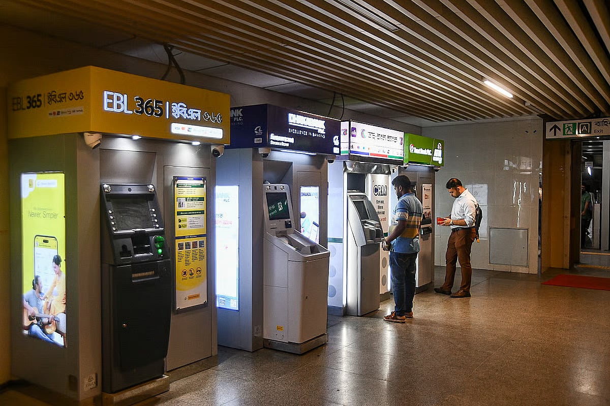 People are seen using automated teller machine (ATM) at a metro rail station in Dhaka