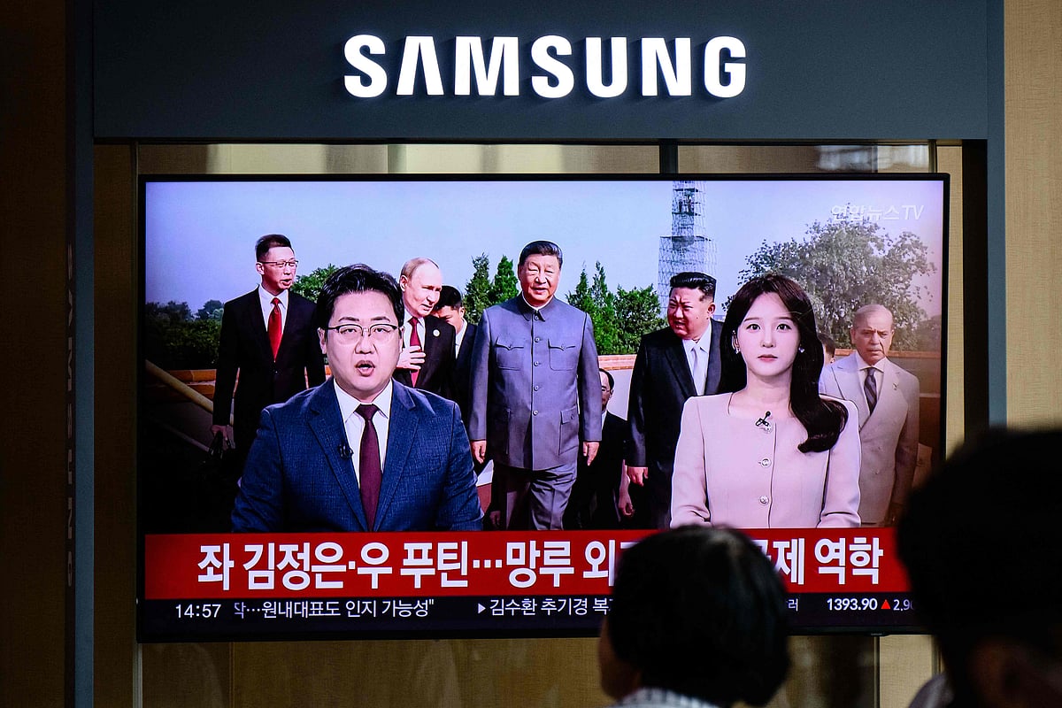 People sit near a television in Seoul on 3 September 2025, broadcasting images of China’s President Xi Jinping (C), North Korean leader Kim Jong Un (centre R), Russia’s President Vladimir Putin (centre L), and Pakistan’s Prime Minister Shehbaz Sharif (R) before a military parade marking the 80th anniversary of victory over Japan and the end of World War II, in Beijing’s Tiananmen Square.