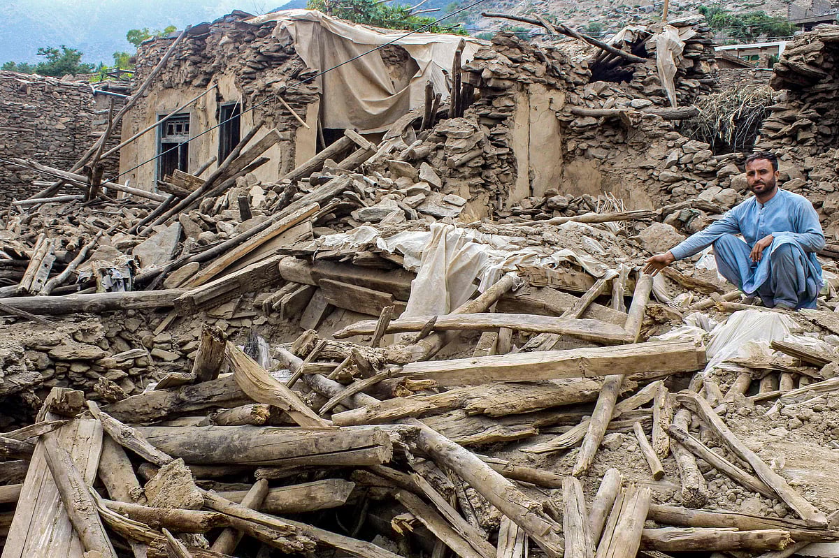 An Afghan man sits amid the remains of a damaged house, in the aftermath of an earthquake at the Dara-i-Nur district of Nangarhar province on 3 September, 2025. Hope was quickly fading of finding survivors in the rubble of homes devastated by the weekend's powerful 6.0-magnitude quake in eastern Afghanistan, as emergency services struggled to reach remote villages on 3 September.