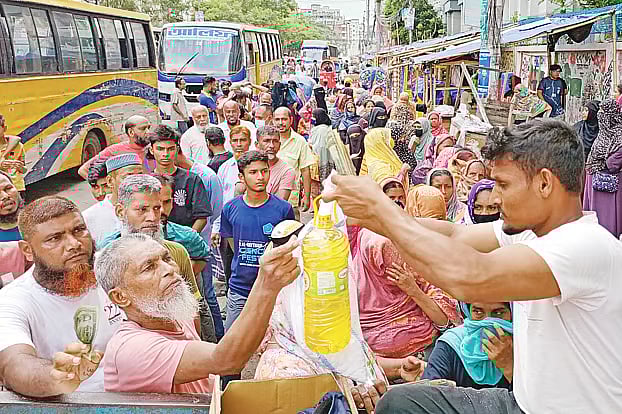 Low-income people purchasing goods from a TCB truck. The photo was taken Thursday afternoon at Japan Garden City in Mohammadpur, Dhaka.
