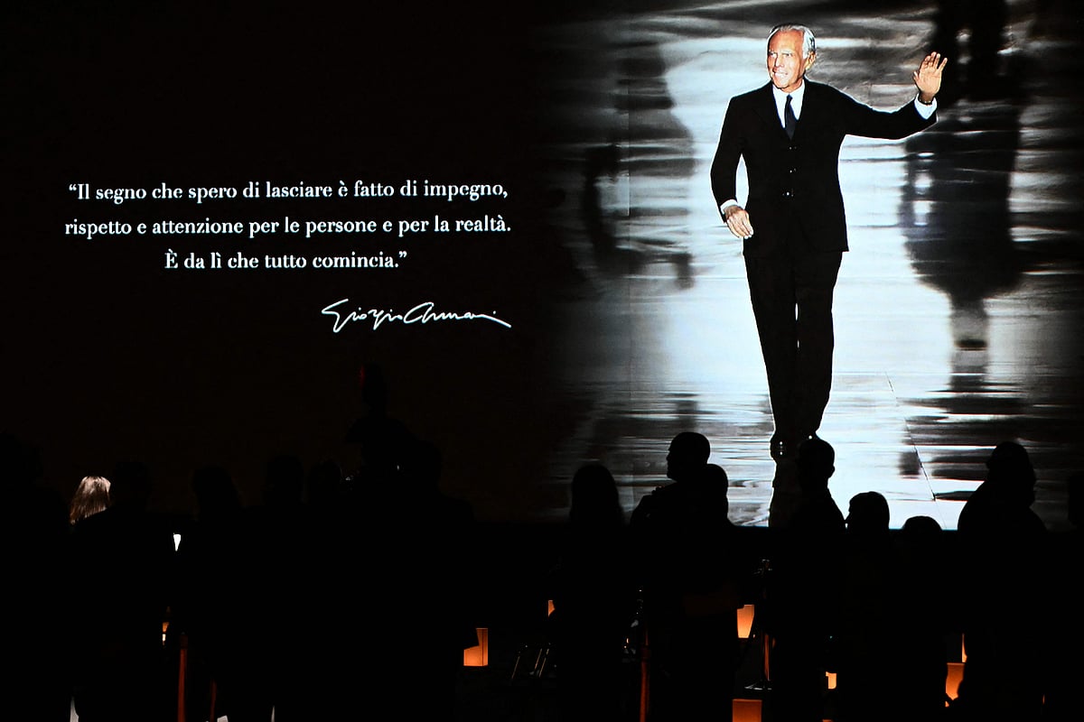 People queue to see the coffin of late Italian fashion designer Giorgio Armani lying-in state for two days at the Armani Theatre in Milan as a picture of him is seen on a screen, on 6 September, 2025. Giorgio Armani died on 4 September, 2025 at 91.