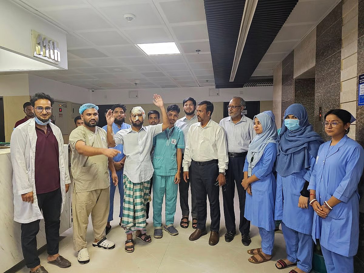 Injured Chittagong University student Mamun Mia is being walked through the hospital corridor. At Parkview Hospital.