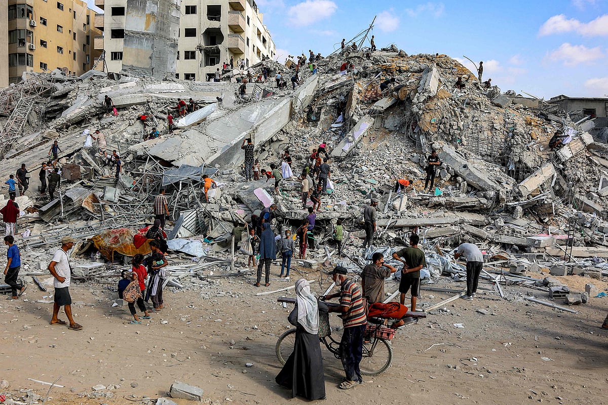 People search for salvage at the mound of rubble at the site of the collapsed Sussi Tower, which was destroyed earlier by Israeli bombardment, in Gaza City on 6 September 2025.