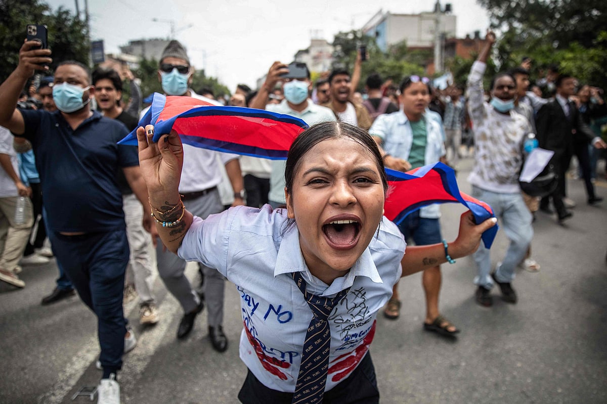 A demonstrator shouts slogans during a protest outside the Parliament in Kathmandu on 8 September, 2025, condemning social media prohibitions and corruption by the government. Nepal police on 8 September opened fire, killing at least 17 people as thousands of young protesters took to the streets of Kathmandu demanding the government lift a social media ban and tackle corruption.