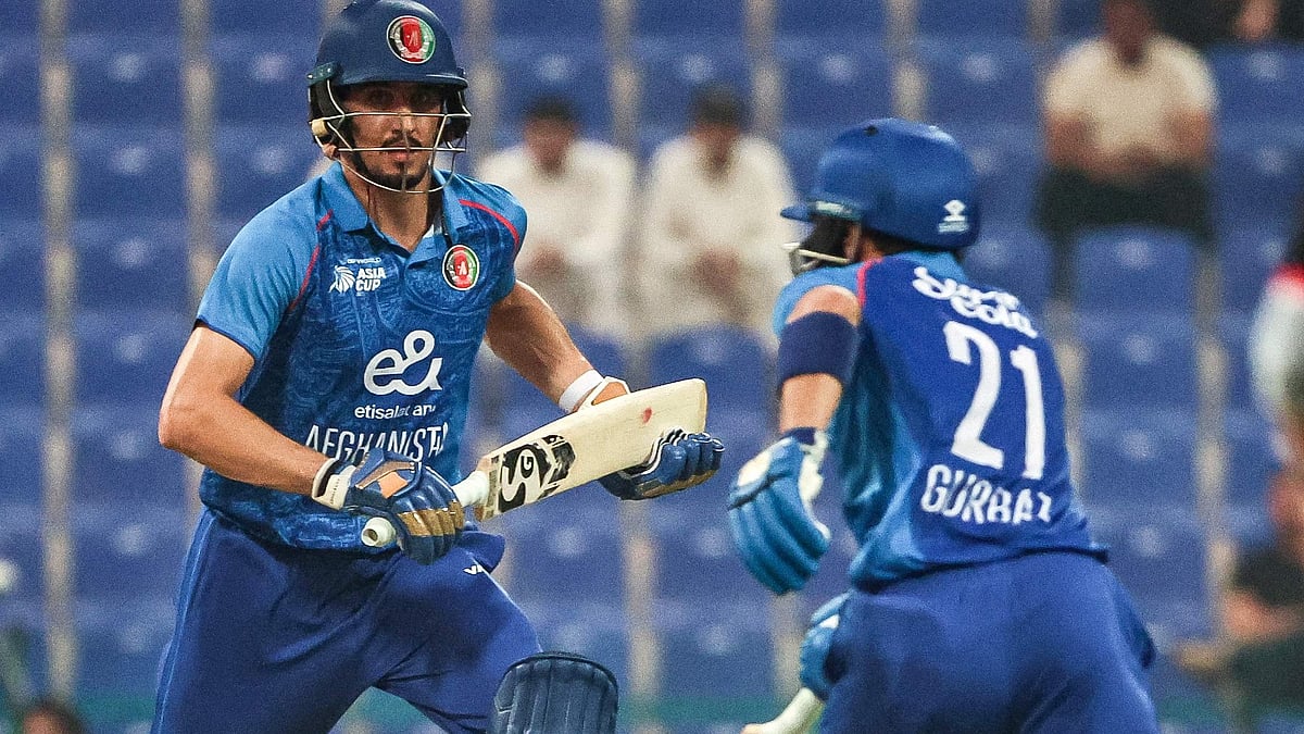 Afghanistan's Sediqullah Atal (L) and Rahmanullah Gurbaz run between the wickets during the Asia Cup 2025 Twenty20 international cricket match between Afghanistan and Hong Kong at the Sheikh Zayed Cricket Stadium in Abu Dhabi on 9 September, 2025