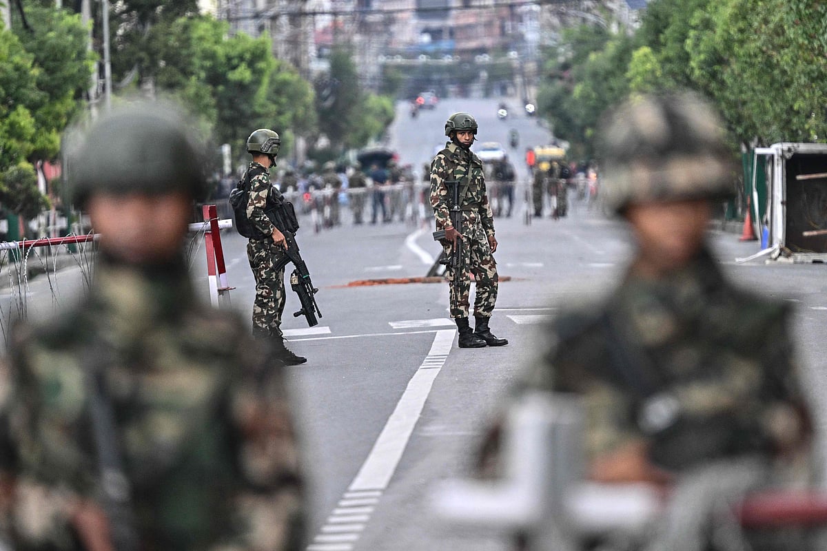 Army personnel stand guard outside Nepal's President House during a curfew imposed to restore law and order in Kathmandu on 12 September, 2025.