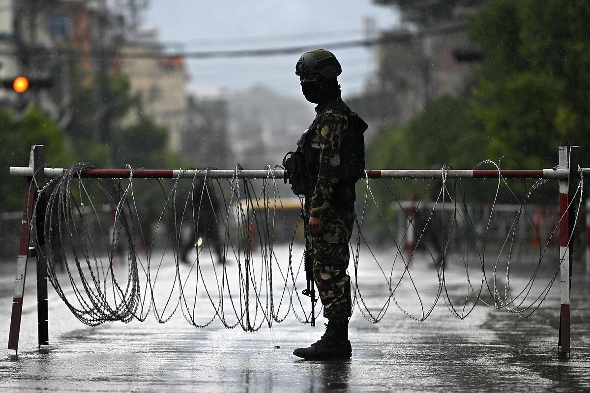 Nepal’s army soldier stands guard along a street in front of the President House during a curfew imposed to restore law and order, in Kathmandu on 12 September 2025