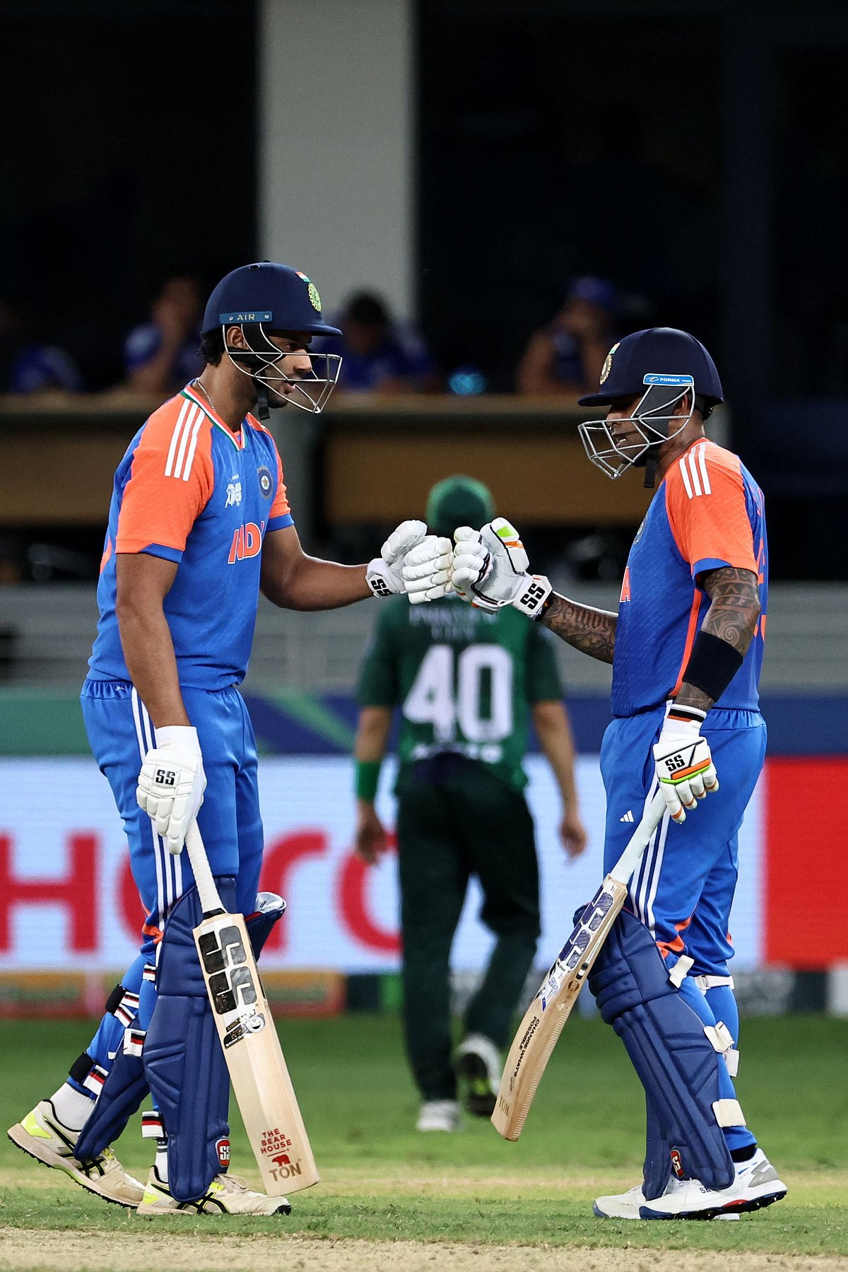 India's Shivam Dube (L) and captain Suryakumar Yadav bump fists during the Asia Cup 2025 Twenty20 international cricket match between India and Pakistan at the Dubai International Stadium in Dubai on September 14, 2025