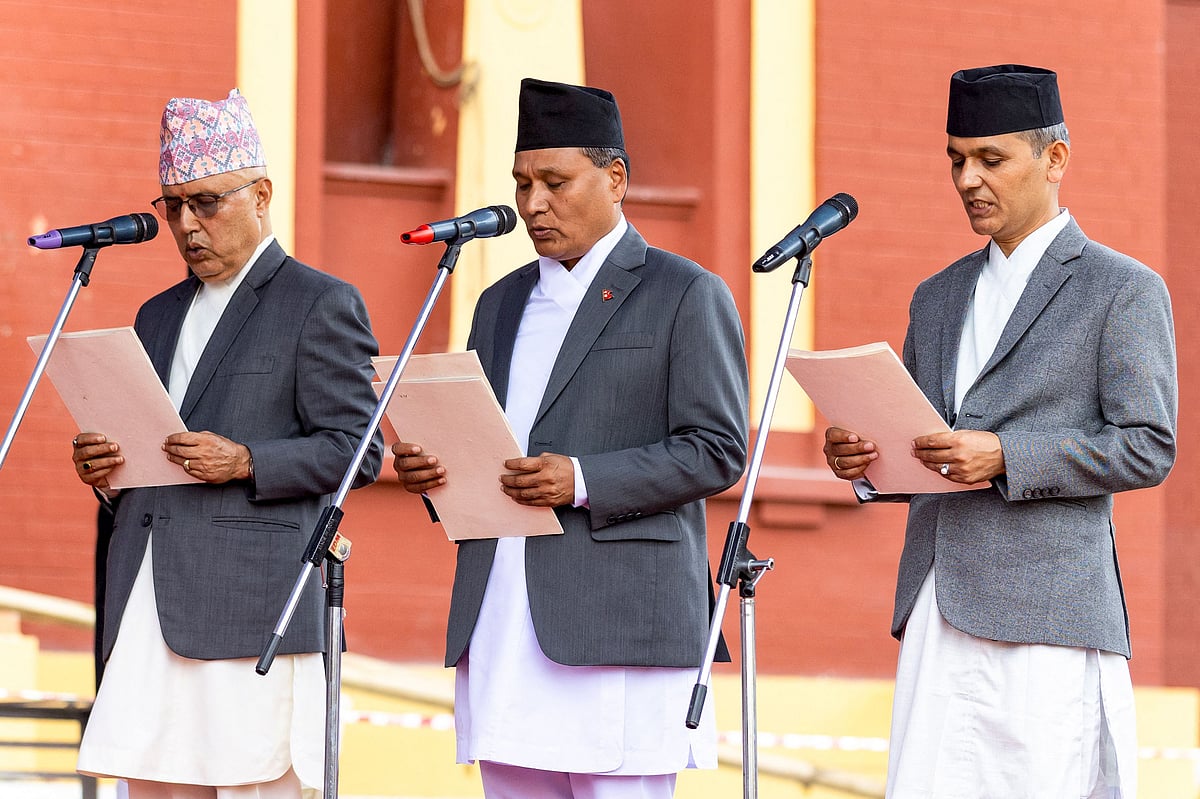 Nepal's newly-appointed ministers of interim government Finance Minister Rameshwor Khanal (L), Home Minister and Minister of Law, Justice and Parliamentary Affairs Om Prakash Aryal (C) and Minister of Energy, Infrastructure, Transport and Urban Development Kulman Ghising take the oath of office during their swearing-in-ceremony at the President House in Kathmandu on 15 September, 2025