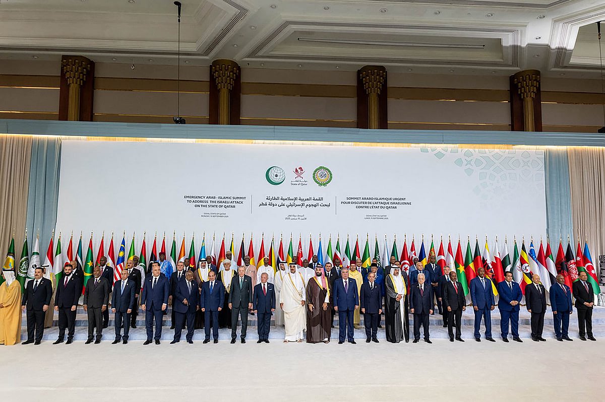 This handout picture released by the he Qatar News Agency (QNA) shows Qatar's Emir Sheikh Tamim bin Hamad Al-Thani (C) posing for a group picture with leaders, heads of state and other officials during the 2025 Arab-Islamic emergency summit in Doha on September 15, 2025