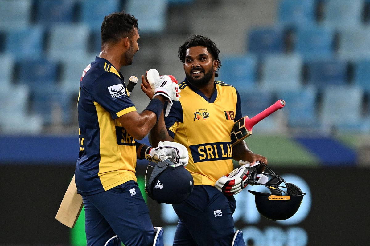 Sri Lanka's Dasun Shanaka (L) and Wanindu Hasaranga celebrate their team's win at the end of the Asia Cup 2025 Twenty20 international cricket match between Hong Kong and Sri Lanka at the Dubai International Stadium in Dubai on September 15, 2025.