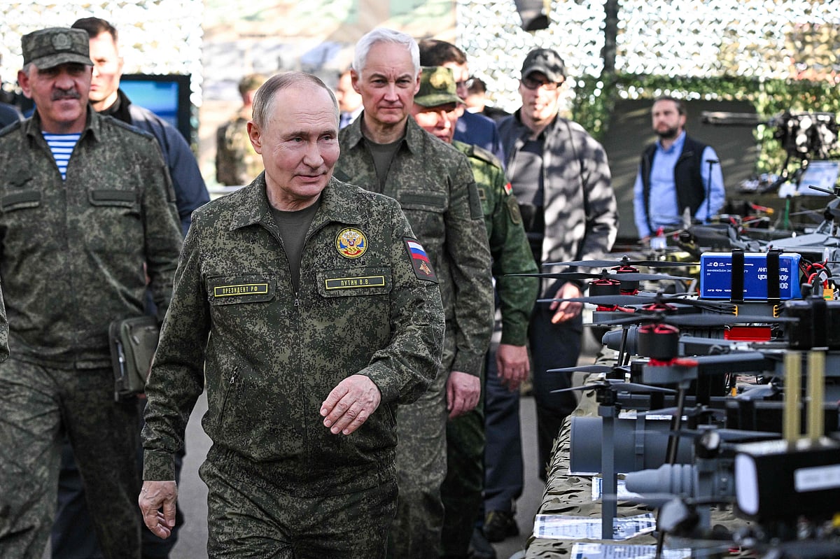 In this pool photograph distributed by the Russian state agency Sputnik, Russia's President Vladimir Putin tours an exhibition of military equipment while inspecting the "Zapad-2025" (West-2025) joint Russian-Belarusian military drills at a training ground in the Nizhny Novgorod Oblast on 16 September 2025.