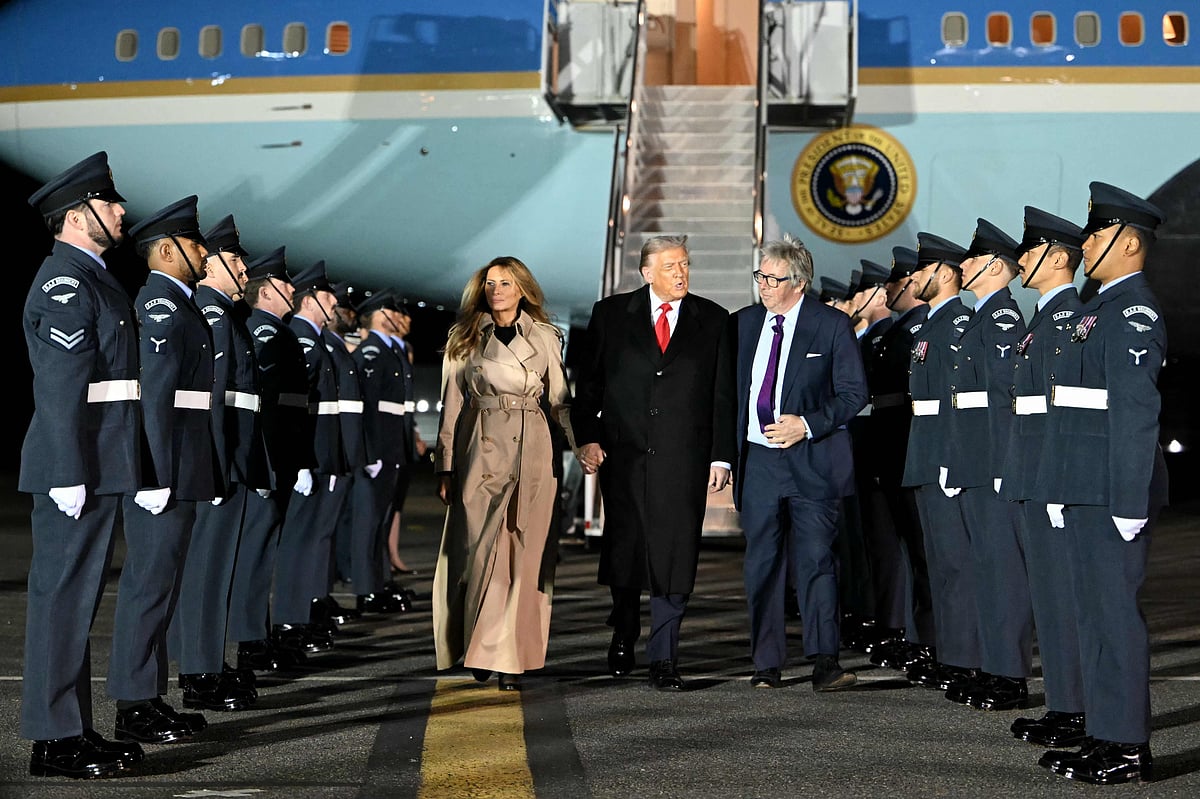 US President Donald Trump (C) and US First Lady Melania Trump disembark from Air Force One after landing at Stansted Airport, eastern England, on September 16, 2025, on the first day of a two-day visit to the UK