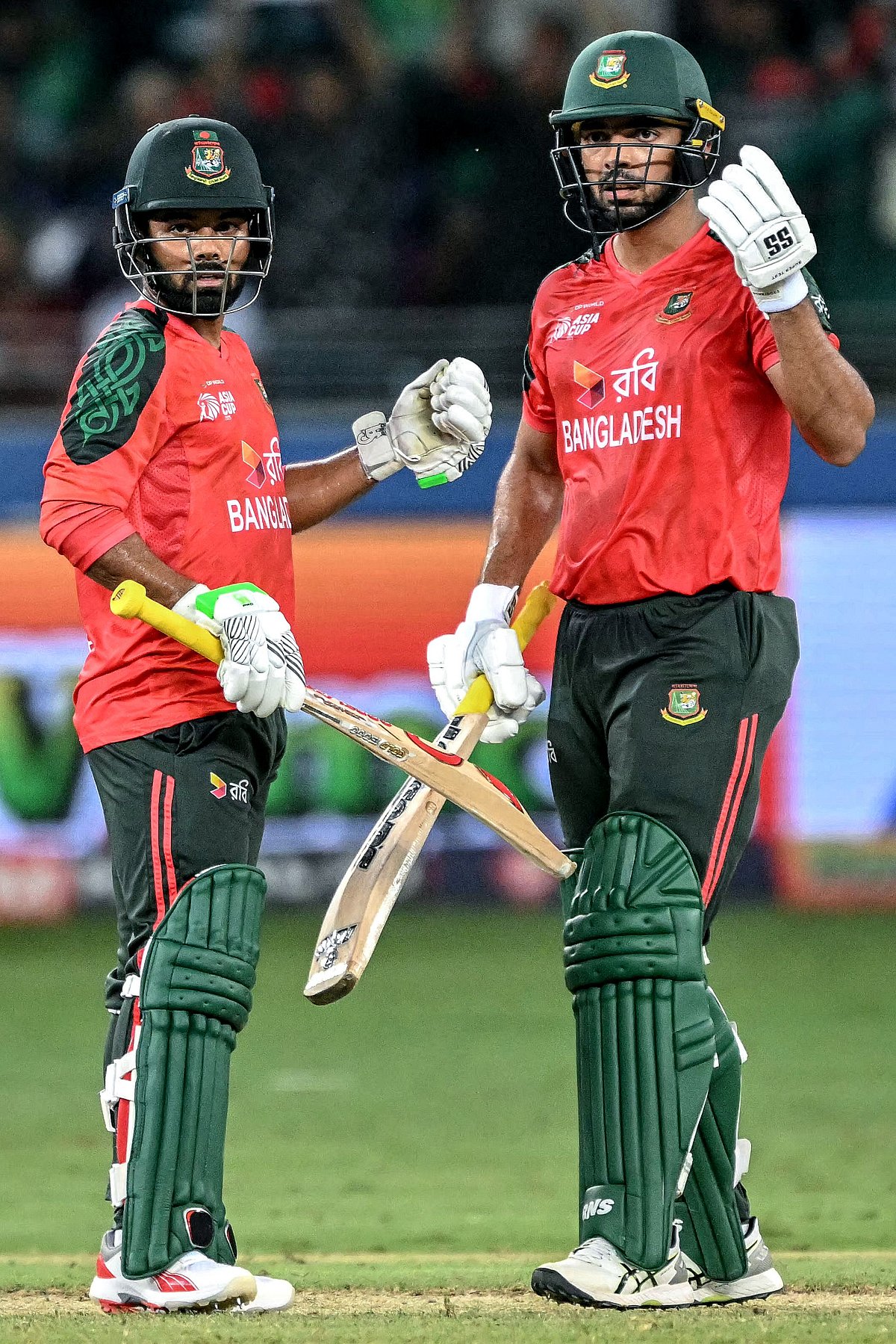 Bangladesh's Saif Hassan (R) and Towhid Hridoy gesture during the Asia Cup 2025 Super Four Twenty20 international cricket match between Bangladesh and Sri Lanka at the Dubai International Stadium in Dubai on September 20, 2025.