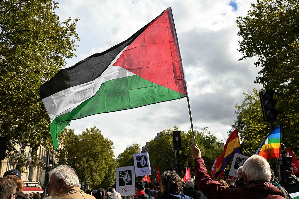 A protester waves a Palestinian flag during a march asking for the "recognition of the State of Palestine and the end of the genocide", in Paris on 21 September, 2025