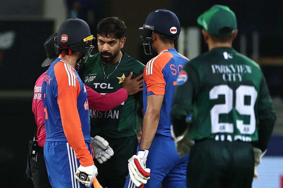 Pakistan's Haris Rauf (3R) speaks with India's Abhishek Sharma (L) as Shubman Gill (2R) watches during the Asia Cup 2025 Super Four Twenty20 international cricket match between India and Pakistan at the Dubai International Stadium in Dubai on 21 September, 2025