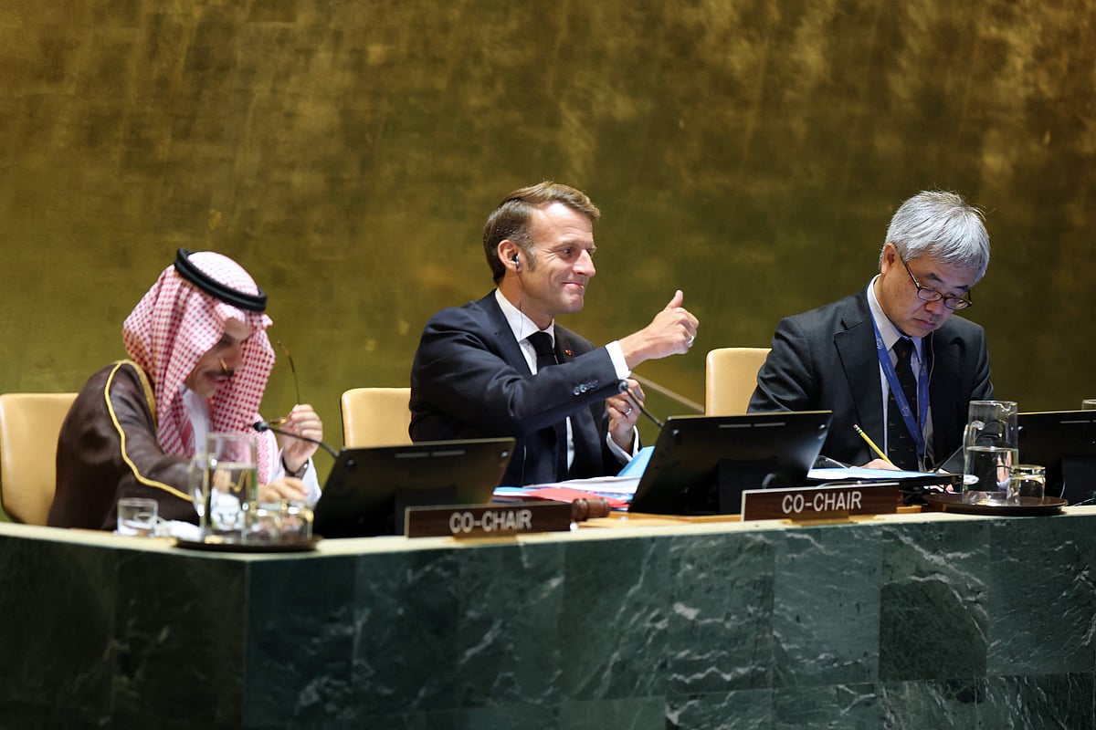 Saudi Arabia’s Foreign Minister Faisal bin Farhan Al Saud (L) and France’s President Emmanuel Macron (C) gesture as they co-chair a United Nations Summit on Palestinians at UN headquarters during the United Nations General Assembly (UNGA) in New York on 22 September 2025