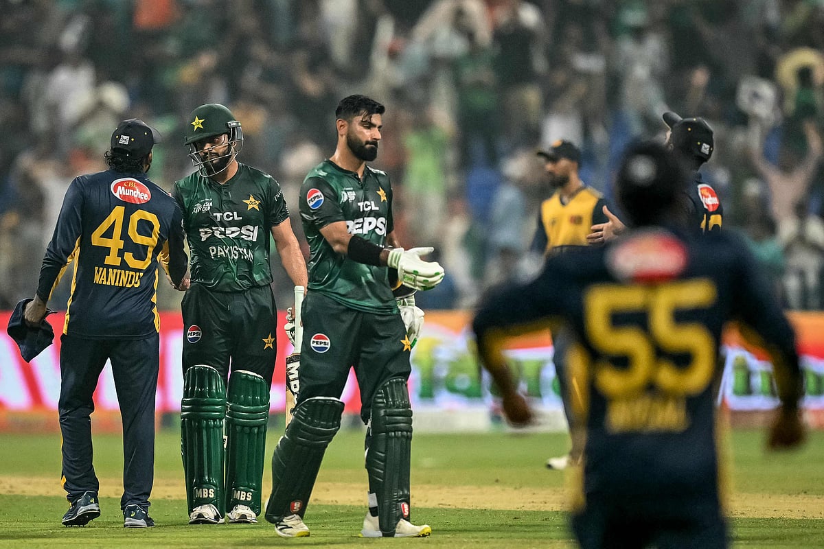 Pakistan’s Hussain Talat (C) and Mohammad Nawaz (2L) shake hands with Sri Lankan players at the end of the Asia Cup 2025 Super Four Twenty20 international cricket match between Pakistan and Sri Lanka at the Sheikh Zayed Cricket Stadium in Abu Dhabi on 23 September 2025