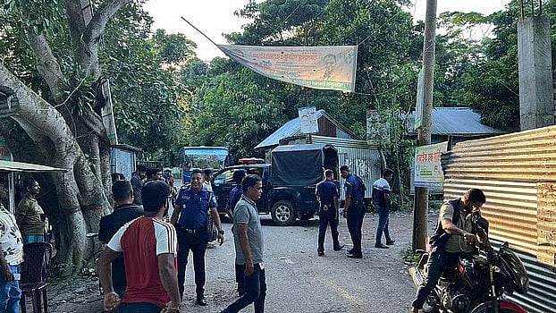 Police members in front of the  family home of a US expatriate Awami League leader from Shariatpur Zahid Hasan as the situation escalated on 23 September, 2025