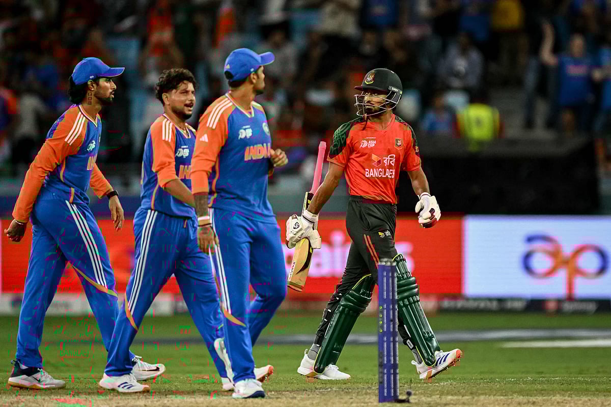 Bangladesh's Tanzim Hasan Sakib (R) walks back to the pavilion after his dismissal during the Asia Cup 2025 Super Four Twenty20 international cricket match between Bangladesh and India at the Dubai International Stadium in Dubai on September 24, 2025.