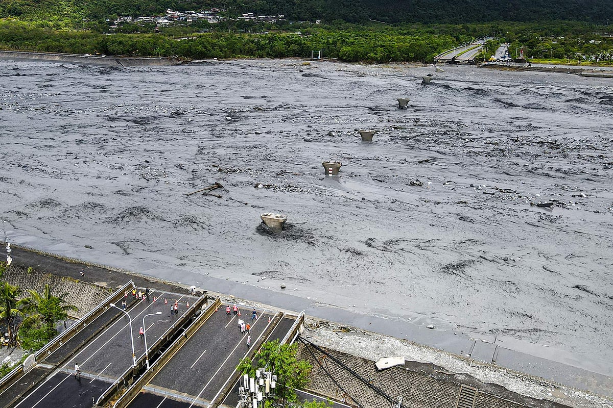 An overview shows flowing mud and floodwaters after a barrier lake burst and caused parts of the bridge over Mataian Creek be destroyed in Hualien on September 24, 2025