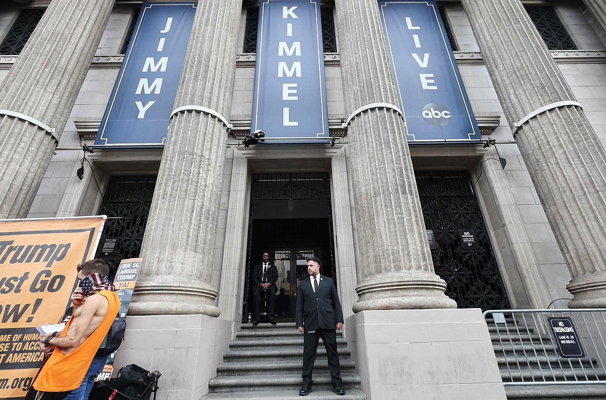 Security workers (C) keep watch outside the El Capitan Entertainment Centre in Hollywood where the “Jimmy Kimmel Live!” show will be recorded on the first night the show will return to the ABC lineup on 23 September 2025 in Los Angeles, California