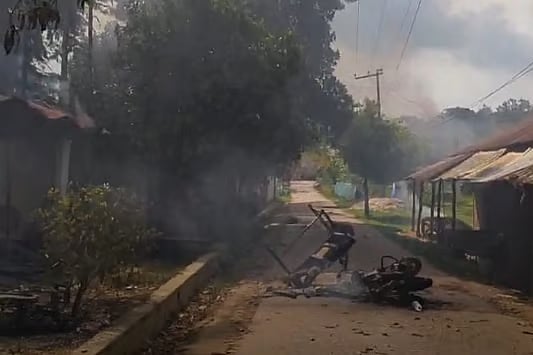 The fire was set to several shops in Ramesu Bazaar of Guimara, Khagrachari. A burned motorcycle is seen in front of one of the shops in the market on Sunday afternoon.