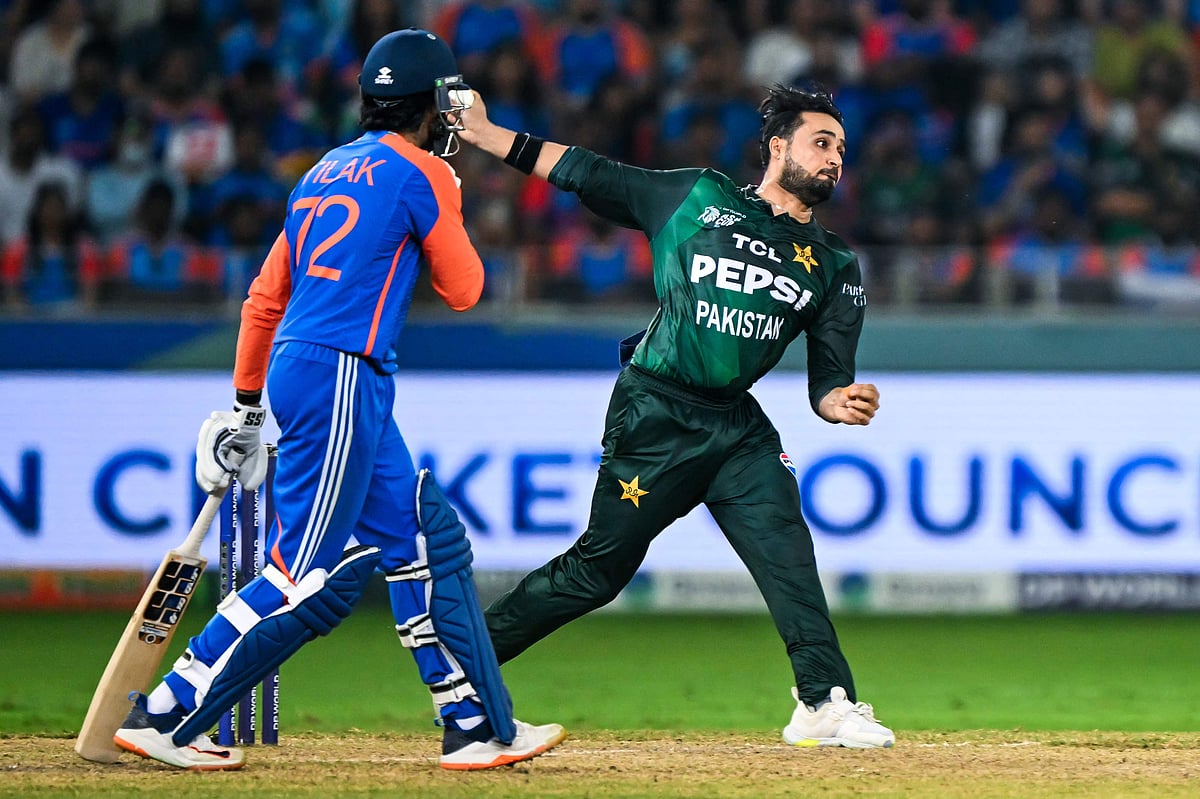 Pakistan's Faheem Ashraf (R) delivers a ball as India's Tilak Varma looks on during the Asia Cup 2025 Twenty20 international cricket final match between India and Pakistan at the Dubai International Stadium in Dubai on 28 September 2025.