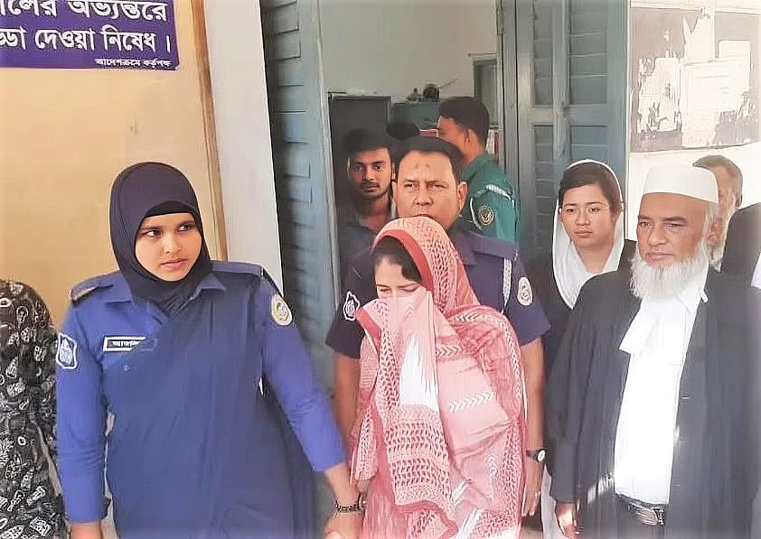 Police escort a convicted defendant to prison following the verdict in a human trafficking case at the Barishal court on 12 November 2024.