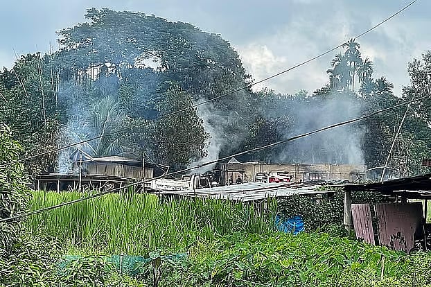 Smoke billows from ruins on the next day after houses are set on fire in Ramesu Bazar area of Guimara, Khagrachhari on 28 September 2025.