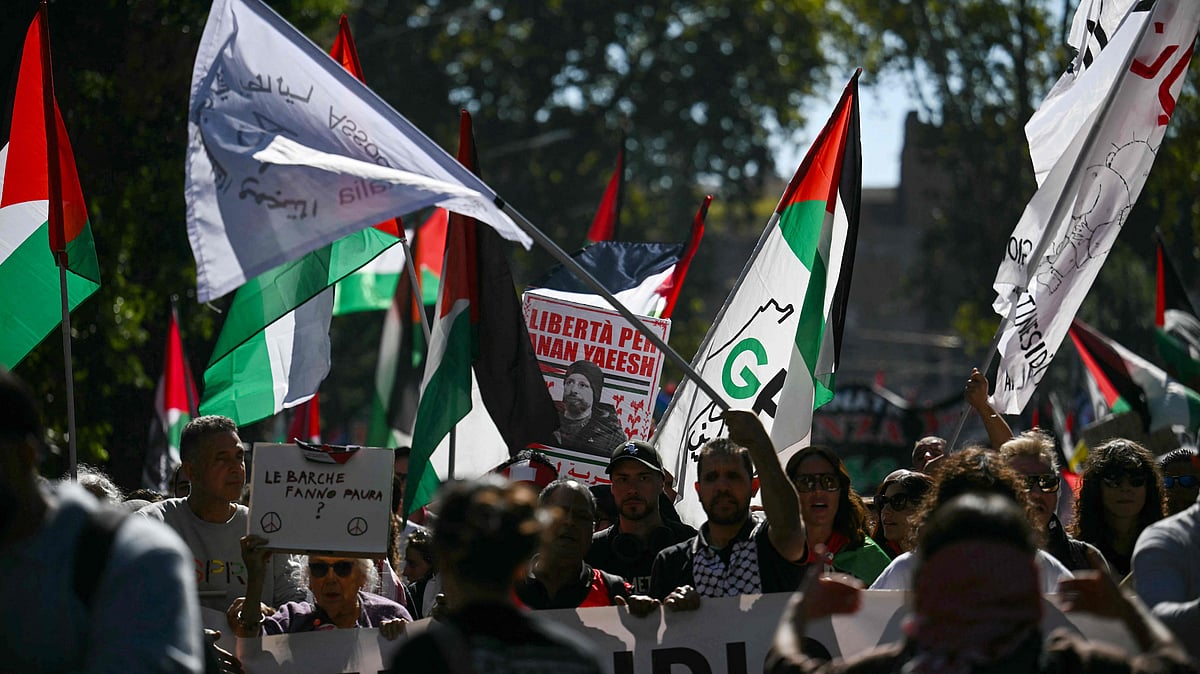 Pro-Palestinian demonstrators wave Palestinian flags as they take part in a protest in support of the Palestinian people and against Israel's interception of the Global Sumud Flotilla, in Rome on 4 October, 2025