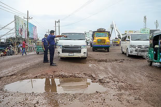 Commuters suffer due to the dilapidated highway. Sarail Bishwa Road intersection.