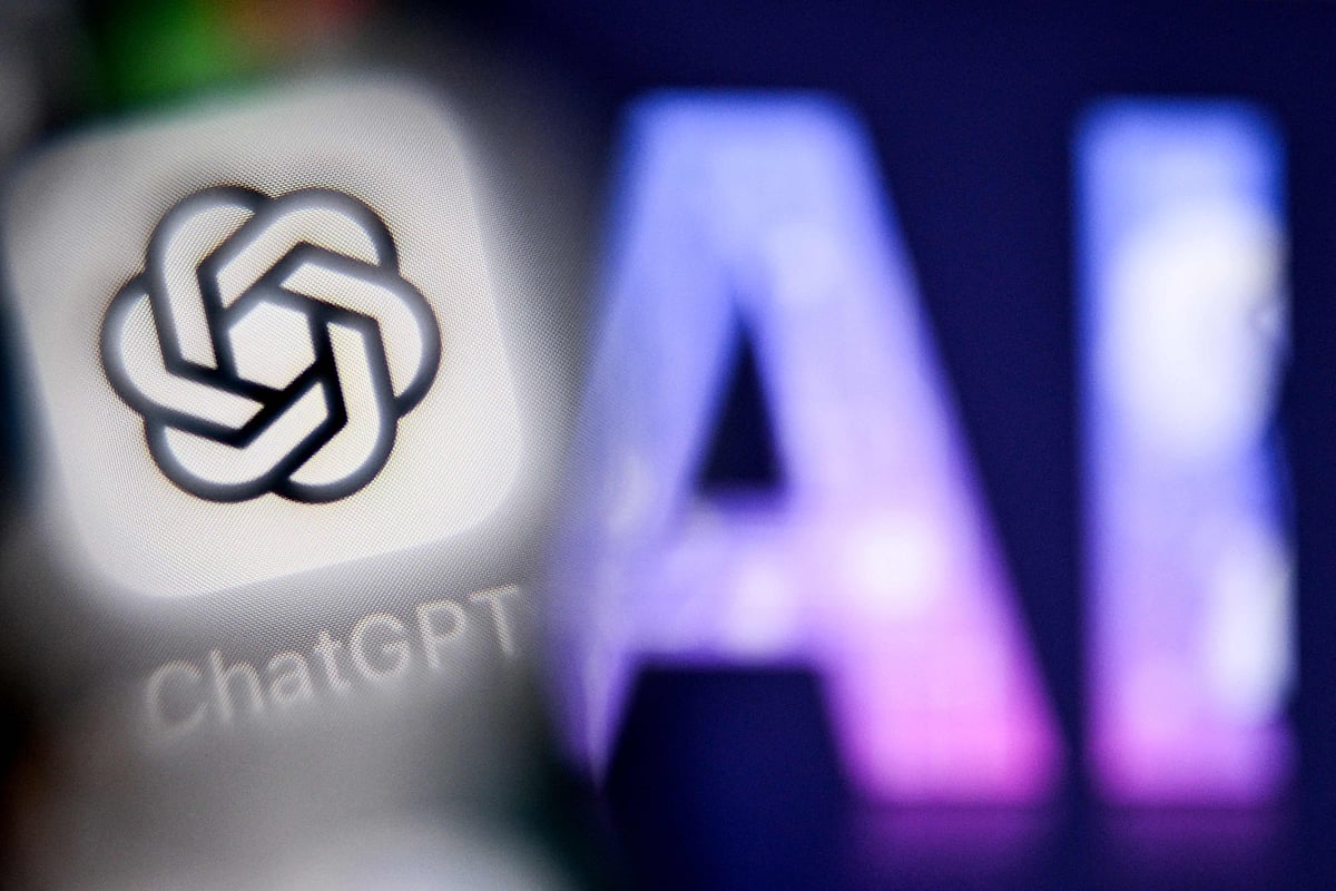 A photo taken on 1 September, 2025 shows the letters AI for Artificial Intelligence on a laptop screen (R) next to the logo of the ChatGPT application on a smartphone screen in Frankfurt am Main, western Germany.