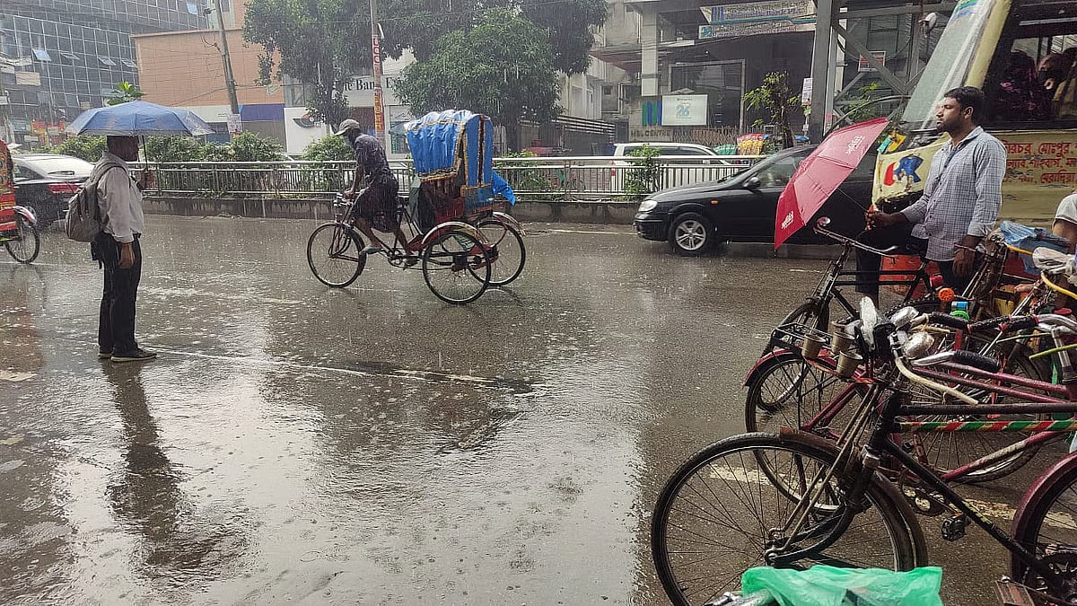 Rain drenched street with people commuting to their destinations. Photo taken from Satmasjid Road in Dhanmondi 15 area of Dhaka on 9 October 2025.