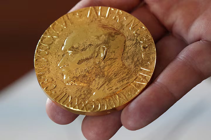 An employee of the Norwegian Nobel Institute holds a replica of a Nobel Peace Medal in the Institute in Oslo, Norway, 9 September, 2025.