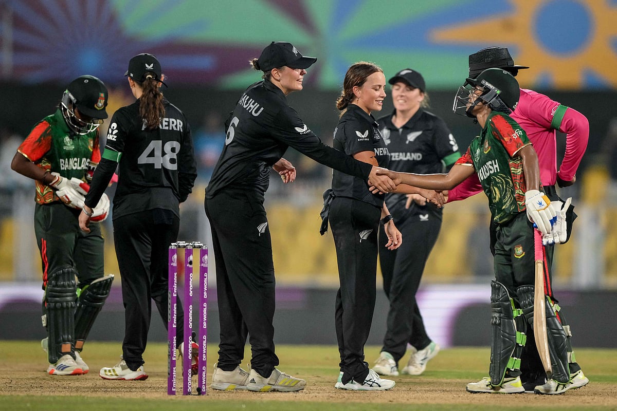 New Zealand’s players shake hands with Bangladesh's players at the end of the ICC Women's Cricket World Cup 2025 one-day international (ODI) match between Bangladesh and New Zealand at the Barsapara Cricket Stadium in Guwahati on 10 October 2025.