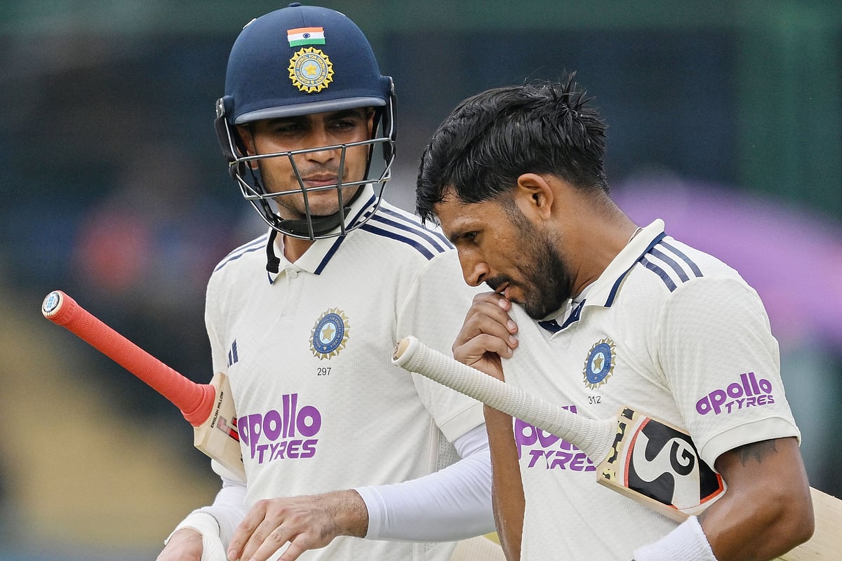 India's captain Shubman Gill (L) and his teammate Dhruv Jurel walk back to the pavilion after India declared their first inning during the second day of the second and last Test cricket match between India and West Indies at the Arun Jaitley Stadium in New Delhi on 11 October 2025.