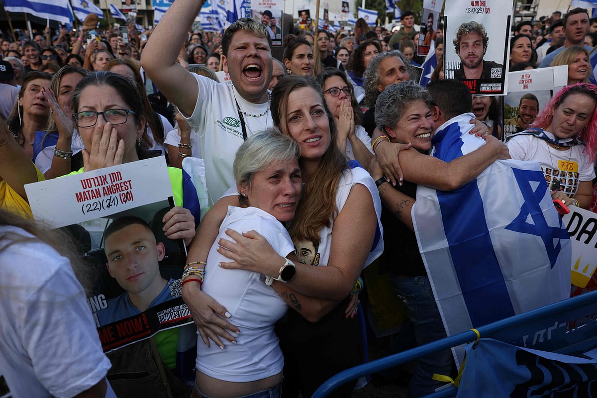 Israelis react as they wait for the release of Israelis still held in Gaza at Hostage Square in Tel Aviv early on October 13, 2025.