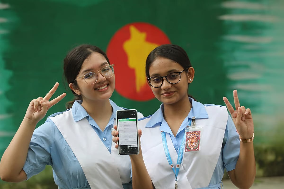 Two students check the HSC exam results at Viqarunnisa Noon School and College, Dhaka, on 15 October 2024.