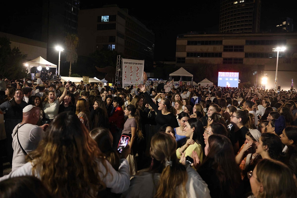 Israeli protesters gather at the Hostage Square in Tel Aviv on October 14, 2025, to celebrate after four more hostages were transferred to the Red Cross in Gaza.