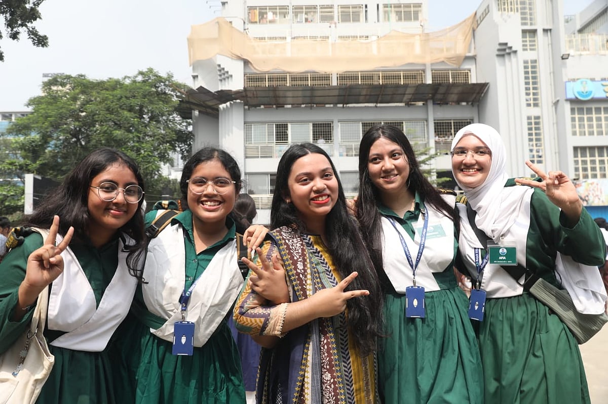 Friends rejoice after receiving their HSC results. Photo taken at Rajuk Uttara Model College in Dhaka on 16 October 2025.