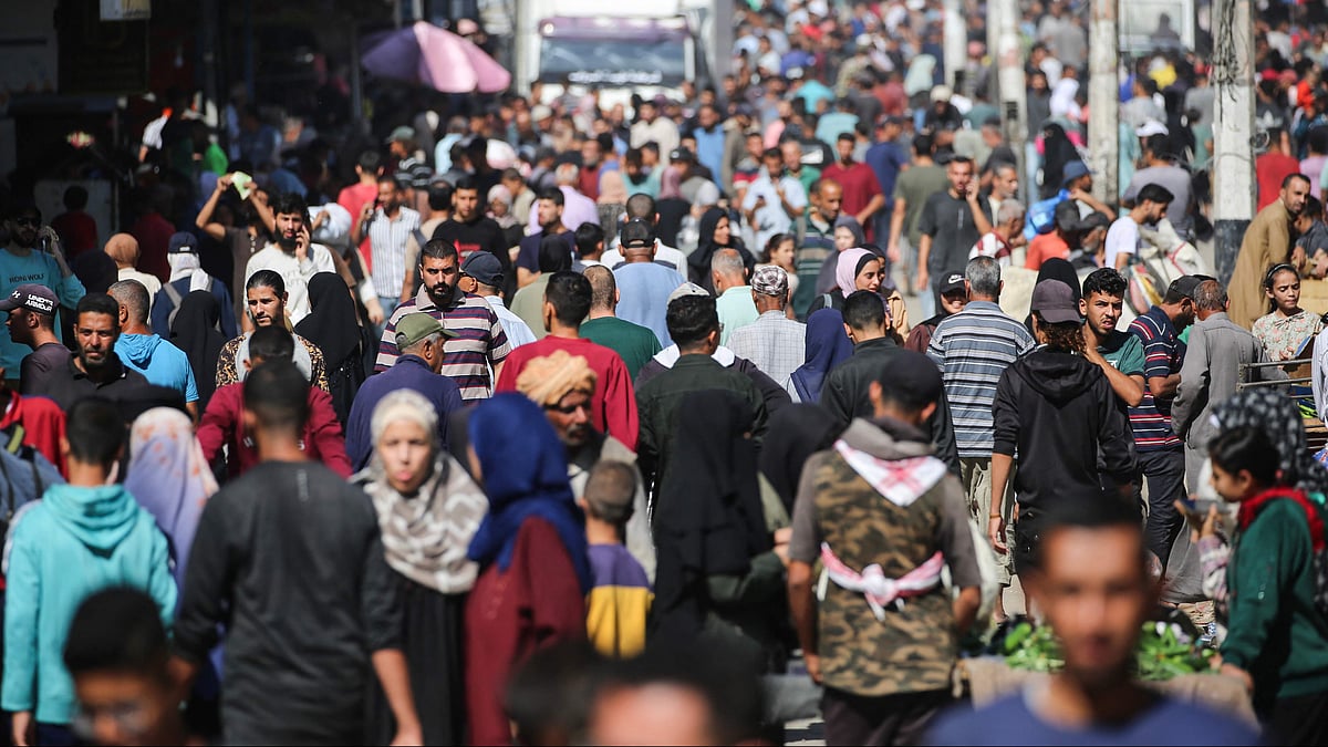 Palestinians shop at a makeshift market in the Nuseirat refugee camp, located in the central Gaza Strip, on 15 October, 2025