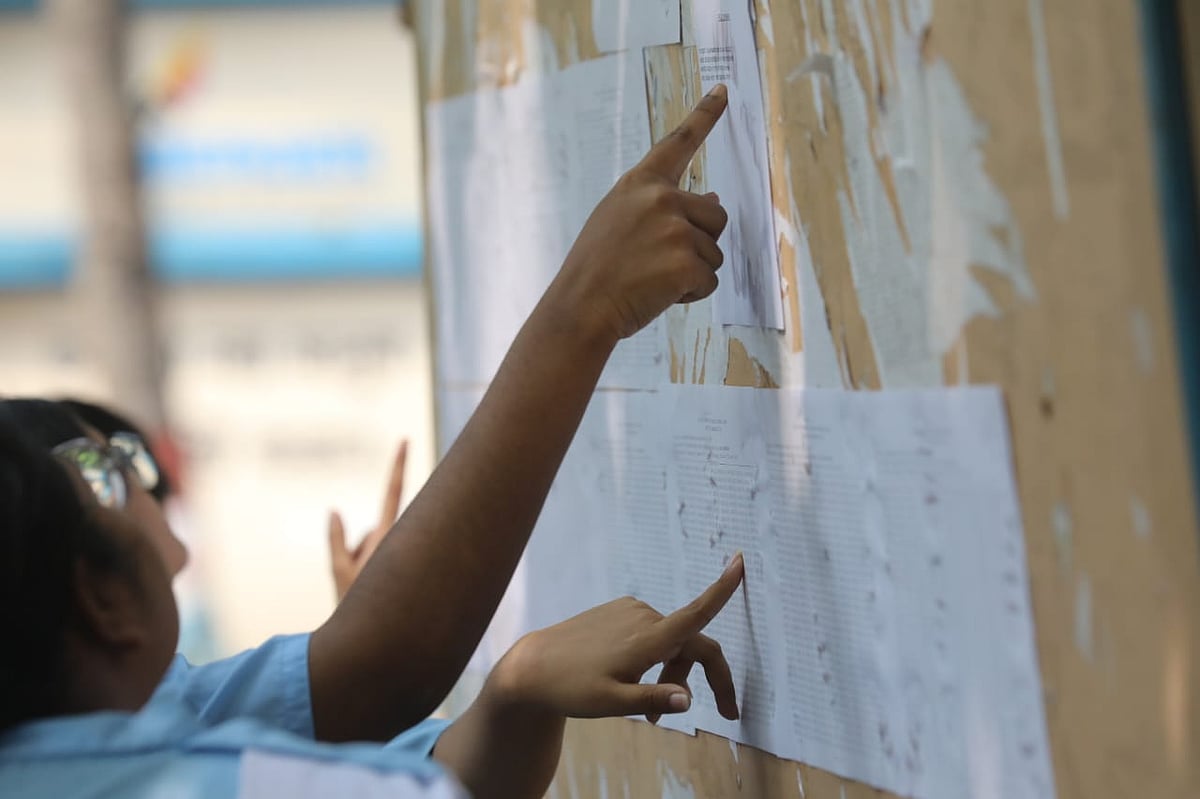 Students search for their roll numbers on the school notice board after the results were published. Photo taken at Viqarunnisa Noon School and College in Dhaka on 16 October 2025.