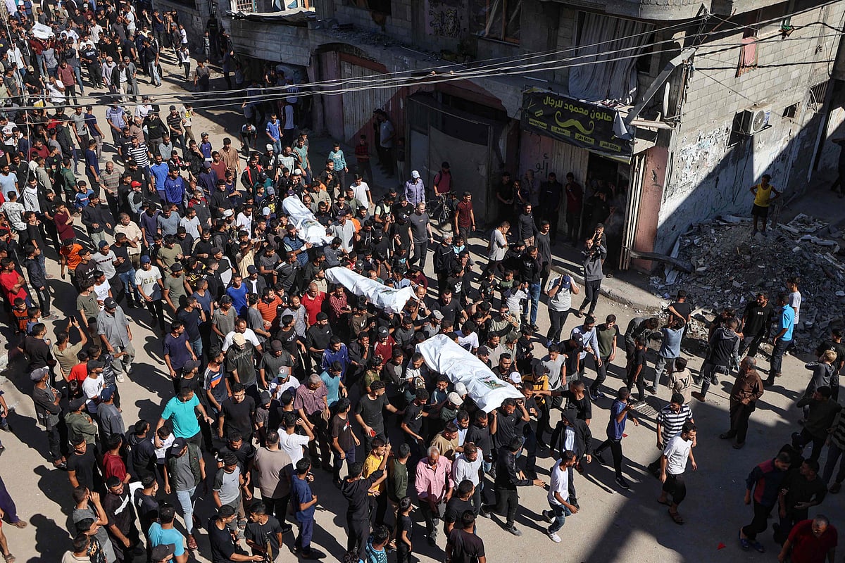 People carry the bodies of Palestinians released by Israel under a Gaza ceasefire and hostage exchange, during their funeral in the Bureij refugee camp in the central Gaza Strip on 18 October, 2025.