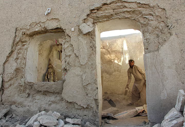 A man clears debris from his house damaged during an airstrike, following a temporary ceasefire, amid the conflict between Afghanistan and Pakistan, in Spin Boldak district of Kandahar Province, Afghanistan.