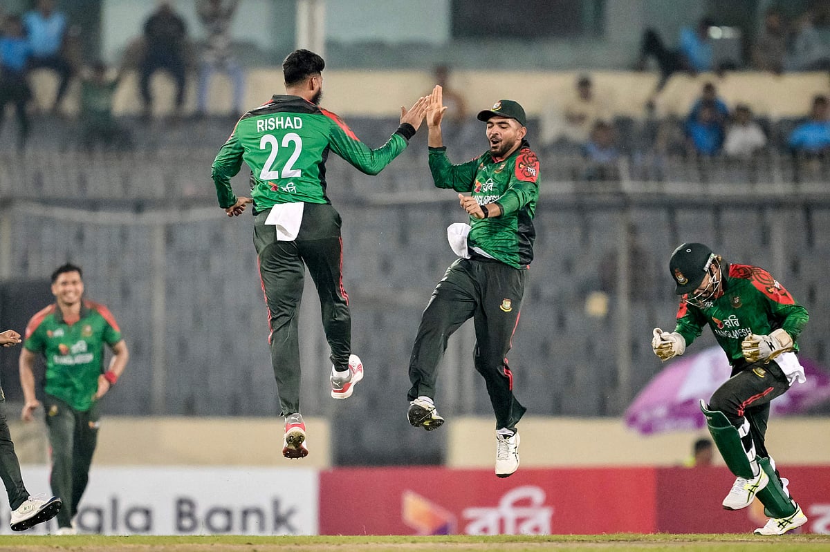 Bangladesh's Rishad Hossain (centre L) celebrates with wicketkeeper Nurul Hasan (centre R) after taking the wicket of West Indies' Brandon King during the first one-day international (ODI) cricket match between Bangladesh and West Indies at the Sher-e-Bangla National Cricket Stadium in Dhaka on 18 October 2025.