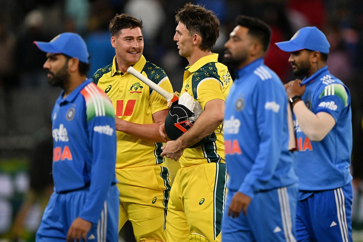 Australia’s captain Mitchell Marsh (C) and Matt Renshaw walk off the field after winning the first one-day international cricket match between Australia and India in Perth on October 19, 2025