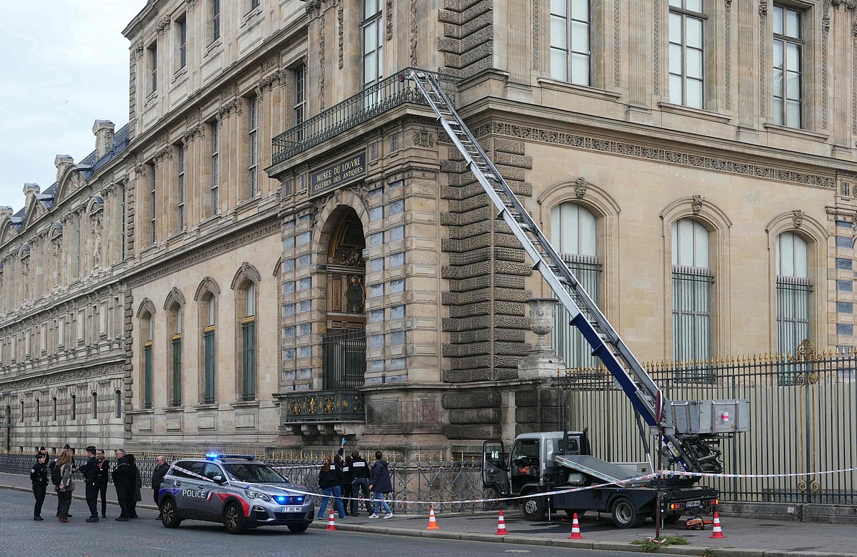 French police officers stand next to a furniture elevator used by robbers to enter the Louvre Museum, on Quai Francois Mitterrand, in Paris on 19 October 2025